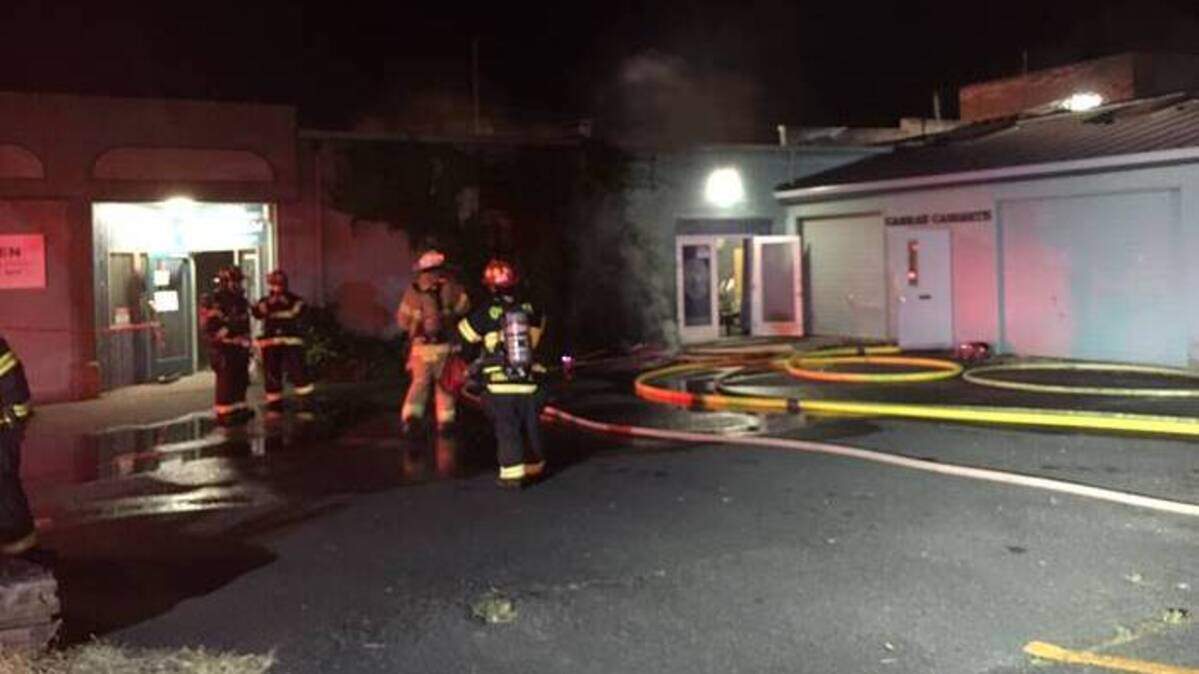 Firefighters respond to a structure fire on the 300 block of State Avenue Northeast in downtown Olympia on Friday night.