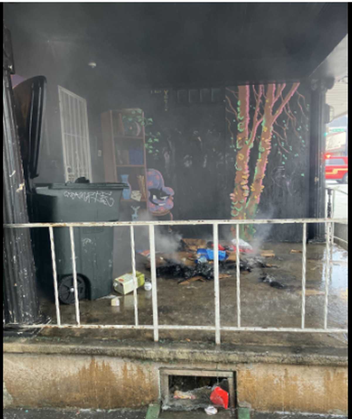 A photo of a pile of debris that burned under a porch at an occupied apartment building on Franklin Street Southeast in downtown Olympia on Tuesday, Jan. 31, 2022.