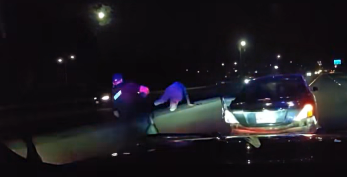 An image shows the woman hopping over a freeway barrier in Tumwater Friday night.