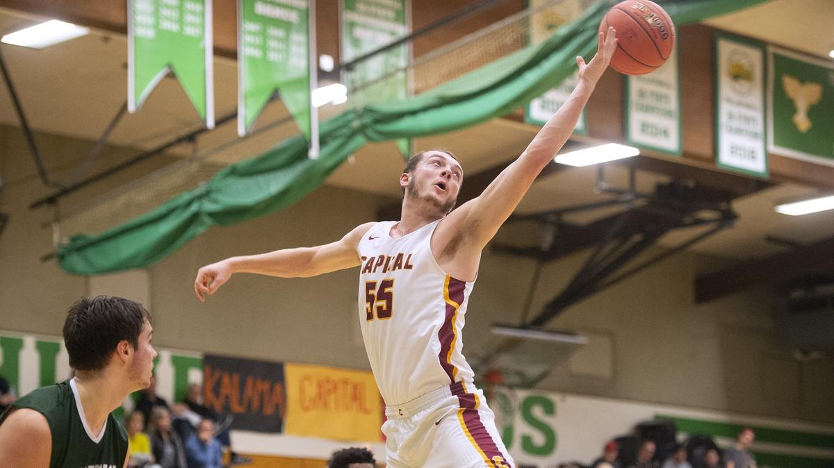 Capital post Grant Erickson stretches for a rebound during the 3A state regional boys basketball game against Shorecrest at Tumwater High School on Saturday, Feb. 23, 2019.