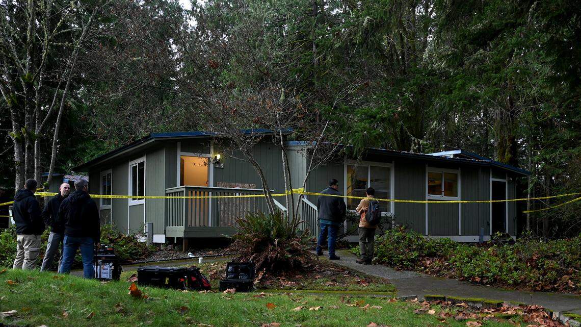Investigators consult with each other Wednesday at the scene of a suspected carbon monoxide poisoning in student modular housing at The Evergreen State College in Olympia. One student died and two other students were hospitalized Monday evening, Dec 11.