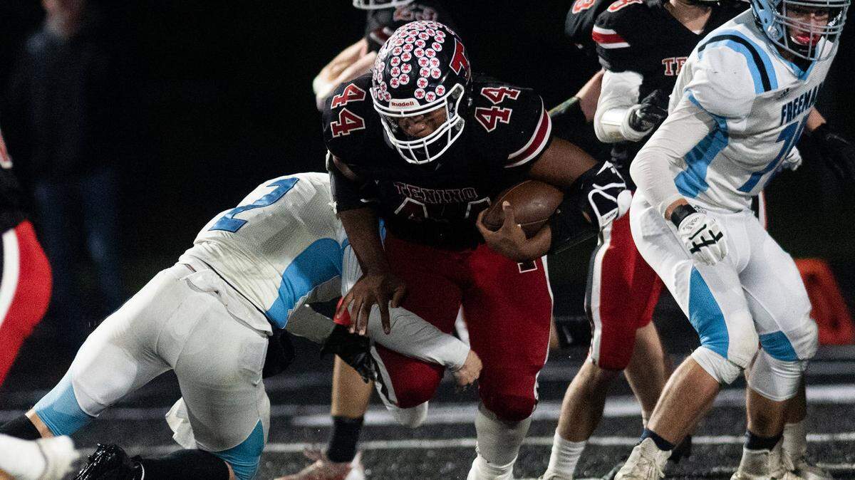 Tenino tailback Takari Hickle breaks through tackles against Freeman in the state playoffs Nov. 12.
