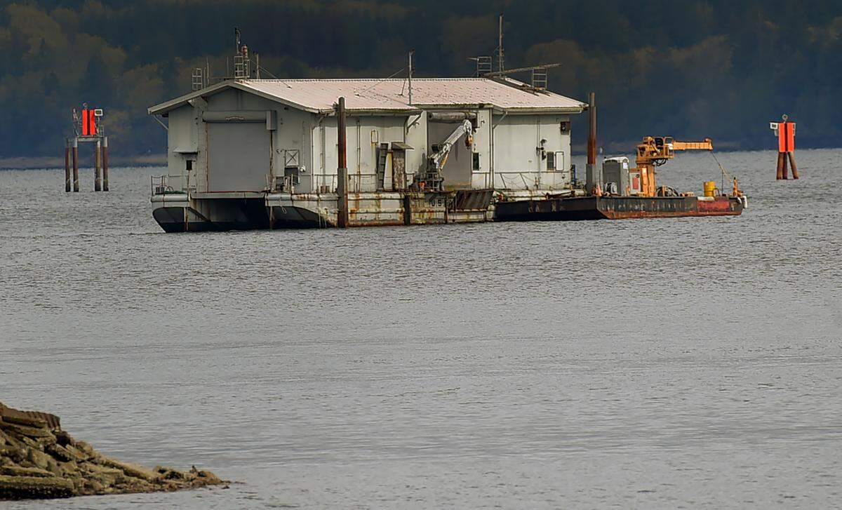 As of Monday afternoon, a former Navy barge now used as a commercial diving platform, still could be seen floating on Budd Inlet near West Bay.