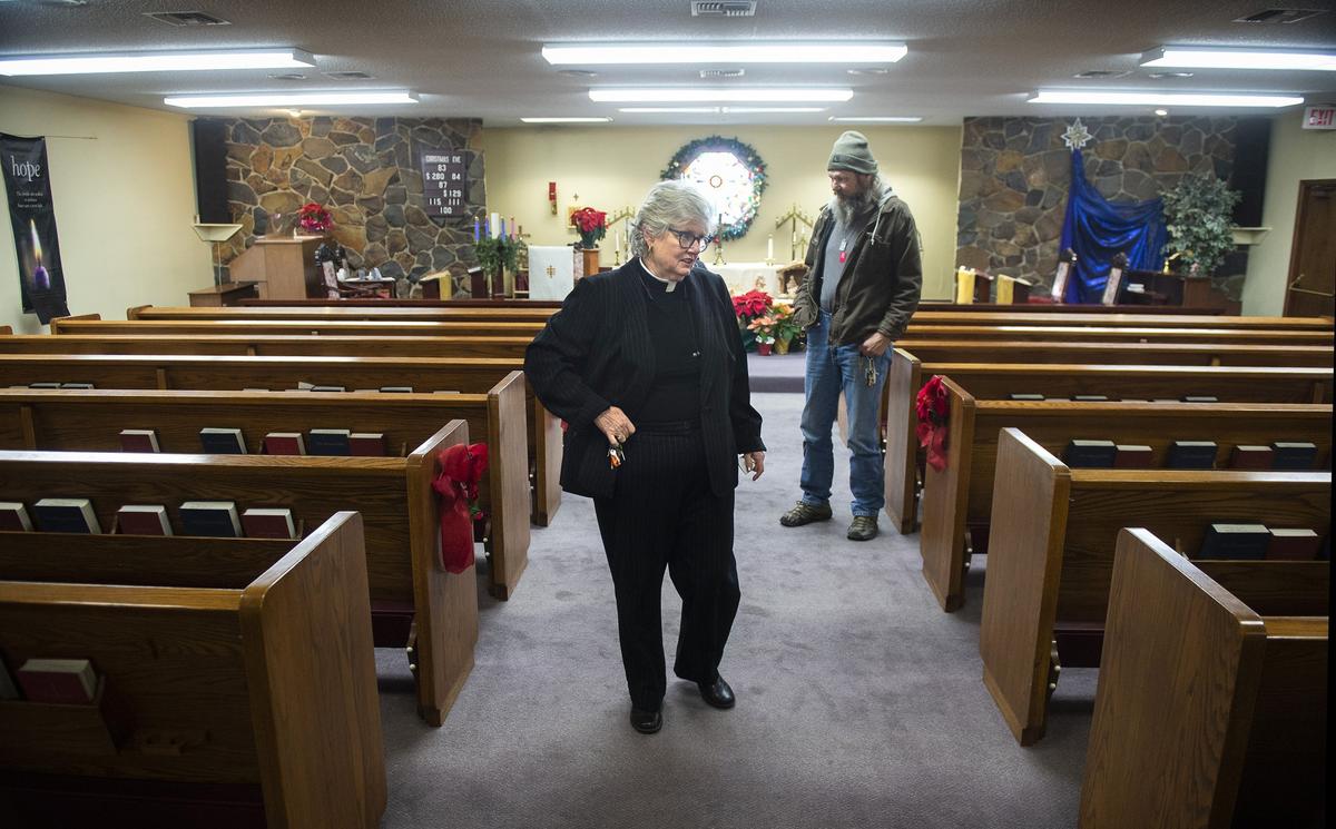The Rev. Nancy Gallagher and David England plan the day’s work at the Episcopal Church of St. John the Divine in Springfield, Oregon. The congregation hosts four people in three Conestoga huts on its property. “We are a little group of old tired people, and we’re on fire,” Gallagher says. “We are mighty, we are fierce. We can’t solve all the problems, but we’re solving problems.”