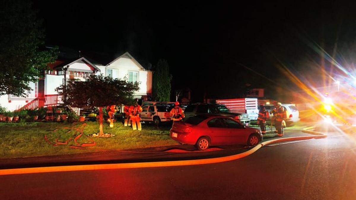 Two people suffered burns and a garage was damaged after it caught fire overnight Tuesday, according to Lacey Fire District 3.