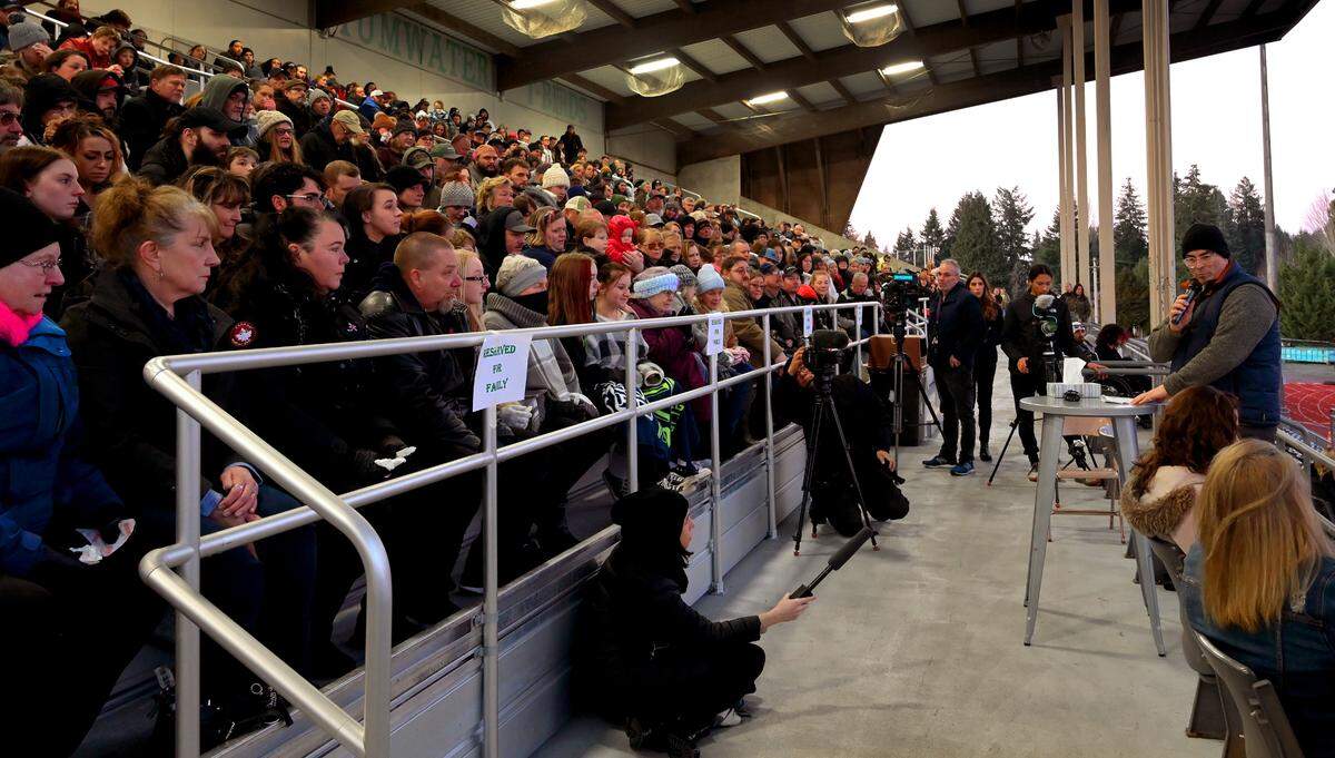 Emcee Jared Burbidge speaks to hundreds of people who gathered at Tumwater Stadium Sunday evening, Jan. 29, to remember the five Cox family members who died in a house fire on Saturday, Jan. 21, at Sherman Valley Ranch near Capitol Forest.
