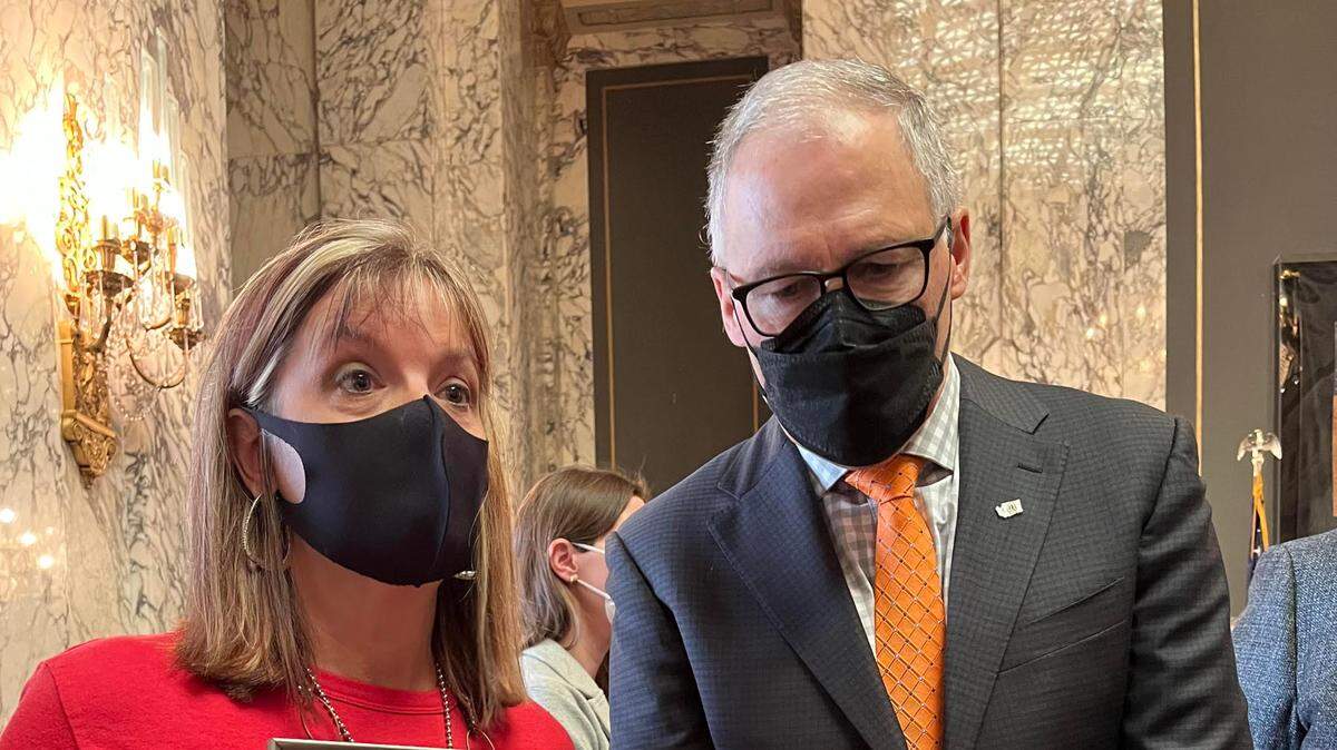 Kim Gatbunton and Gov. Jay Inslee speak to reporters Wednesday about the passage of new gun legislation. Gatbunton, whose son Joshua was killed in 2008 by gun violence, testified on nearly all the gun safety bills introduced this session, she said.