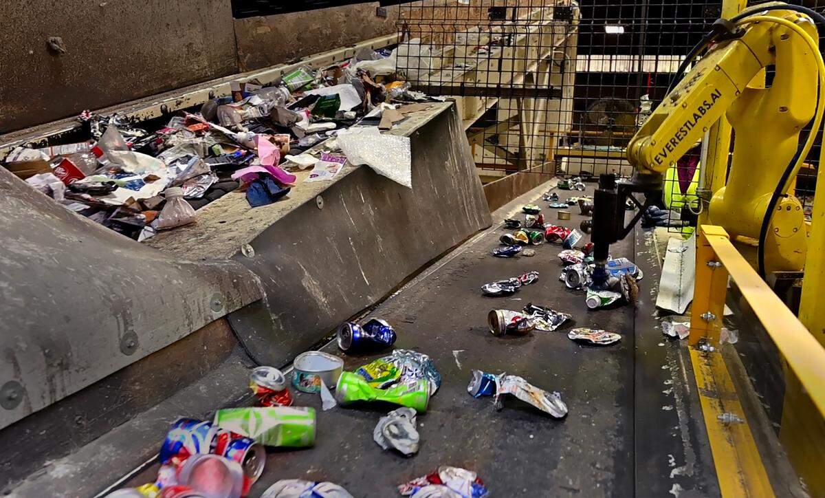 Waste Connection’s Government Affairs Manager Rick Vail leads a Jan. 17 tour of the Pioneer Recycling Services’ Material Recovery Facility (MRF) near Tacoma, Wa. Shown here is a robotics’ sorting unit