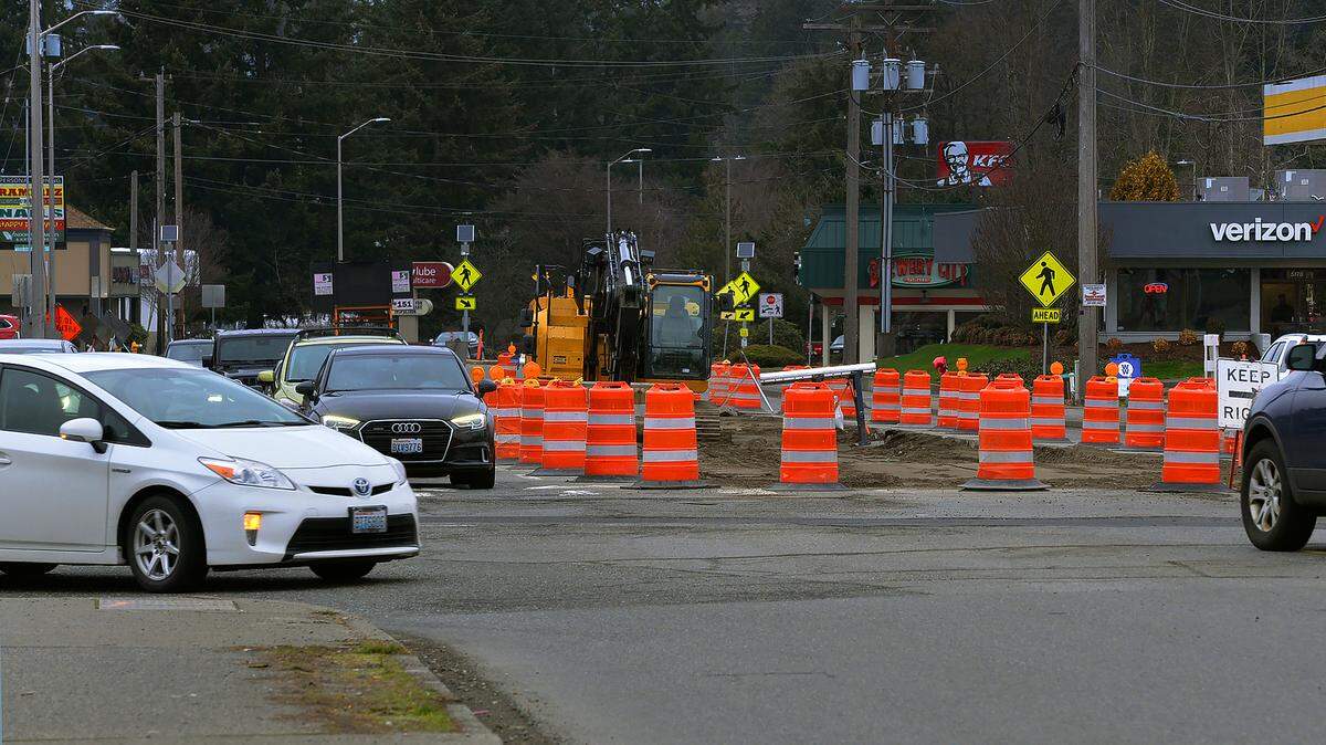 Cars navigate cones and extended lane closures Monday, Feb. 20, 2023, as construction on Tumwater’s Capitol Boulevard and Trosper Road intersection continues.