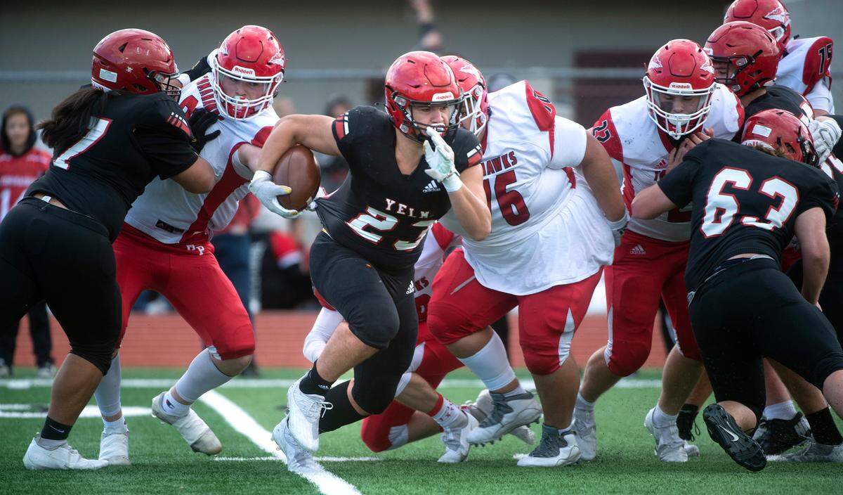 Yelm running back Brayden Platt looks for running room against the Marysville-Pilchuck defense during Saturday afternoon’s 3A football state quarterfinal game at Yelm High School in Yelm, Washington, on Nov. 20, 2021. Marysville-Pilchuck won the game, 39-21.