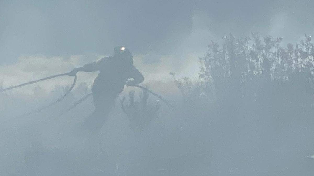 Fire fighter works to contain a five-acre fire near Rochester.