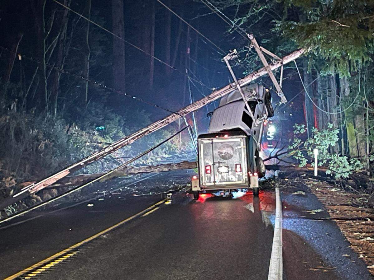 A Jefferson County woman driving north on U.S. Highway 101 hit downed power lines near Lilliwaup; her 2008 Dodge Dakota became suspended but she was not injured.