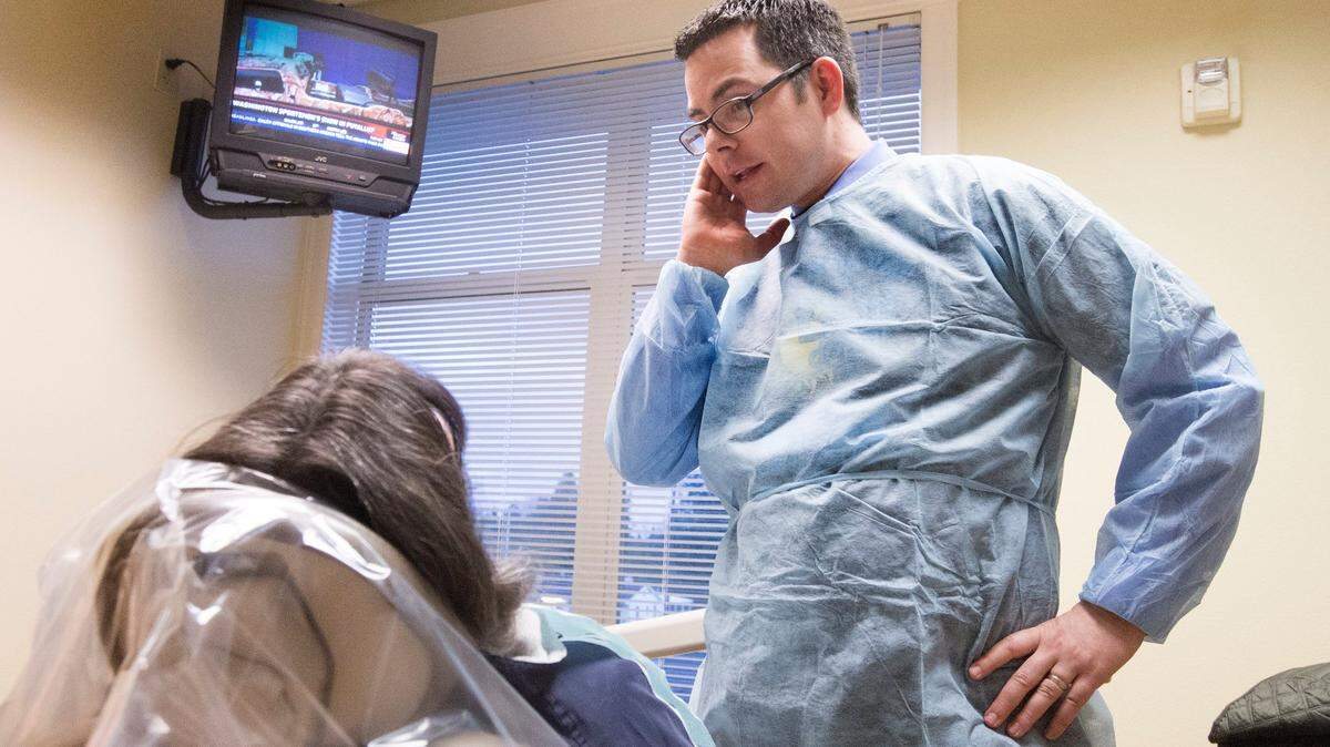 Dr. Adam Poyfair of Puyallup talks to a patient about gum disease. Gum disease often goes hand in hand with diabetes, high blood pressure and heart disease in adults.