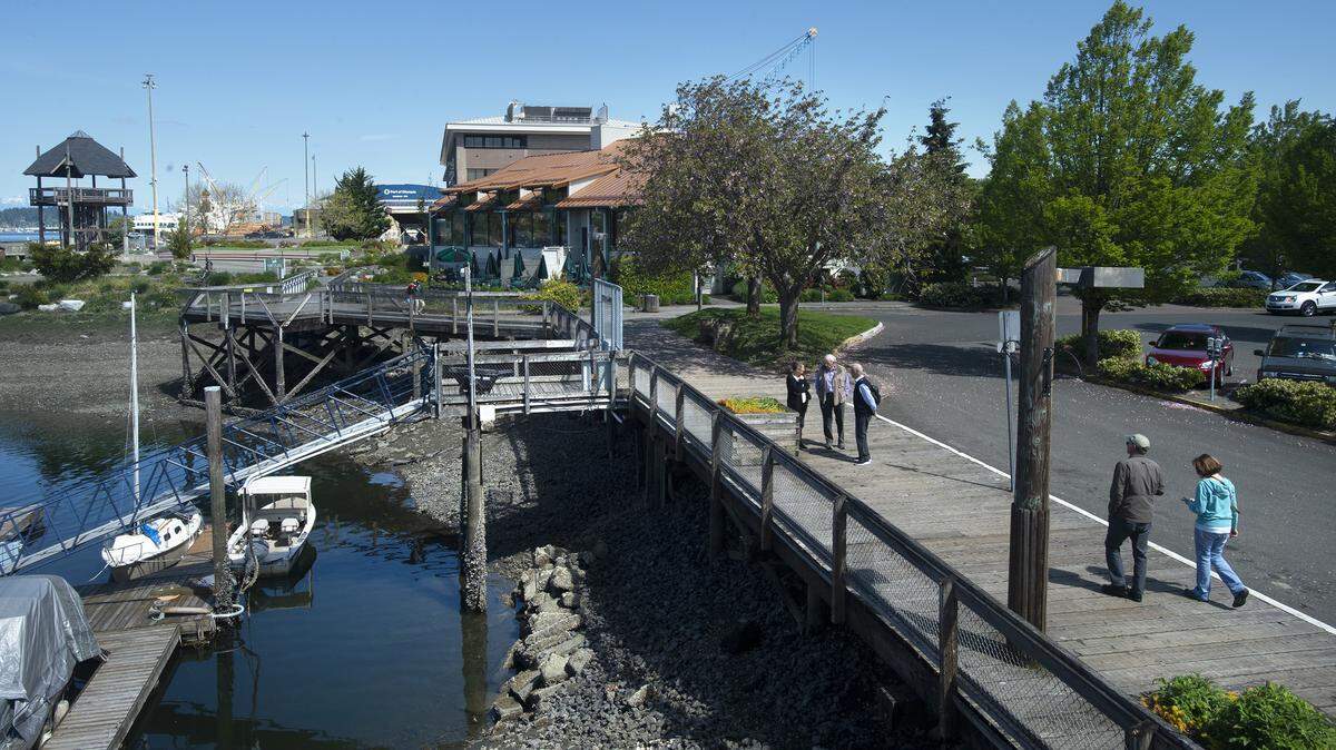 Pedestrians make their way along the Percival Landing boardwalk on Columbia Street near the Port Plaza and Farmers Market in downtown Olympia. Olympia Design Month will look at urban design that encourages and discourages people to get out and walk around.