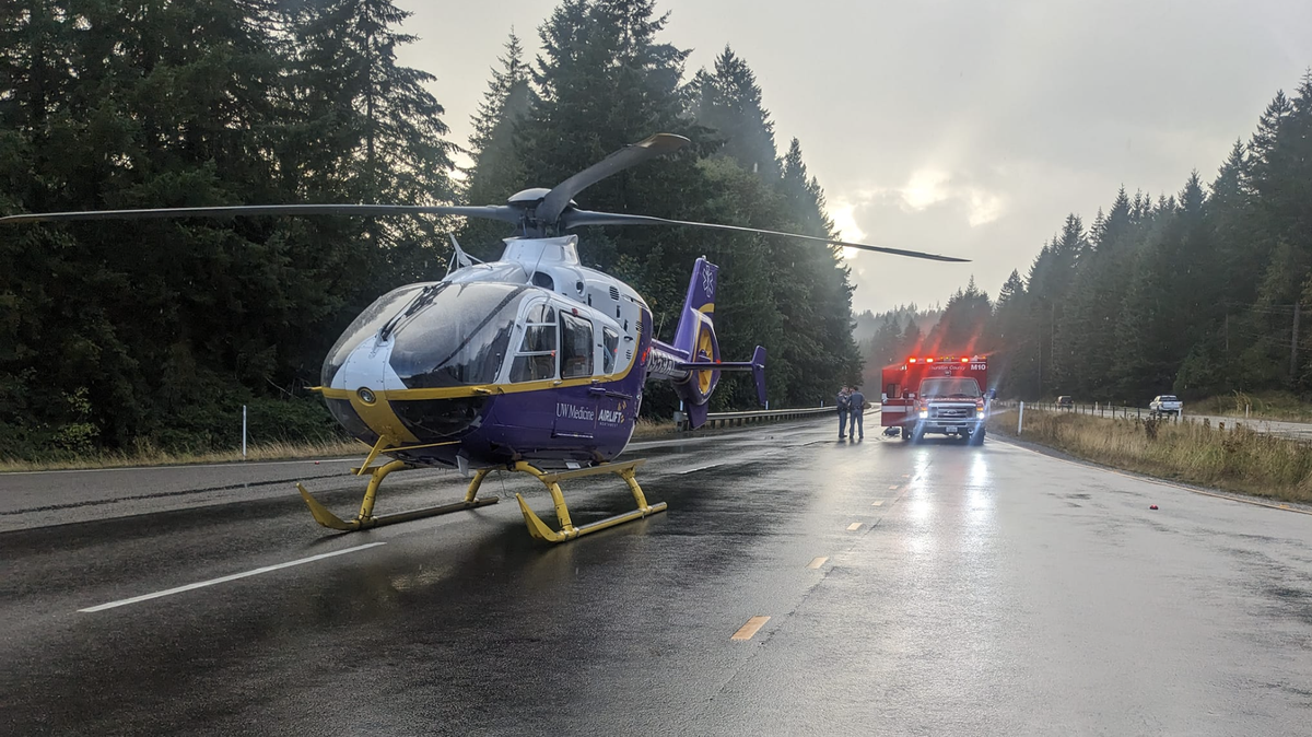 An Airlift Northwest helicopter with purple University of Washington Medicine branding landed on State Route 8 near Summit Lake in Thurston County on Wednesday, Sept. 11, 2024, to airlift a patient from the scene of a single-vehicle car crash.