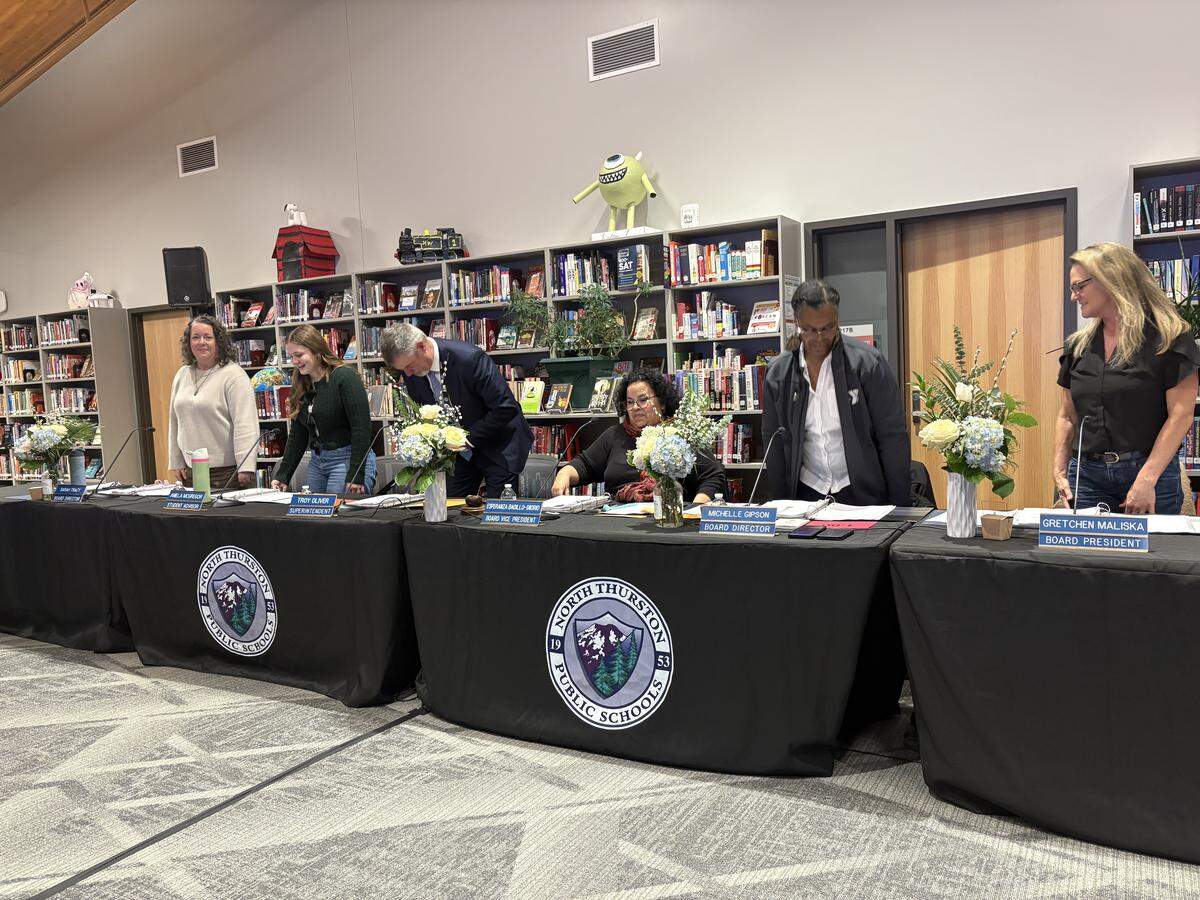 The North Thurston Public Schools board gathered Tuesday in the new River Ridge High School library.