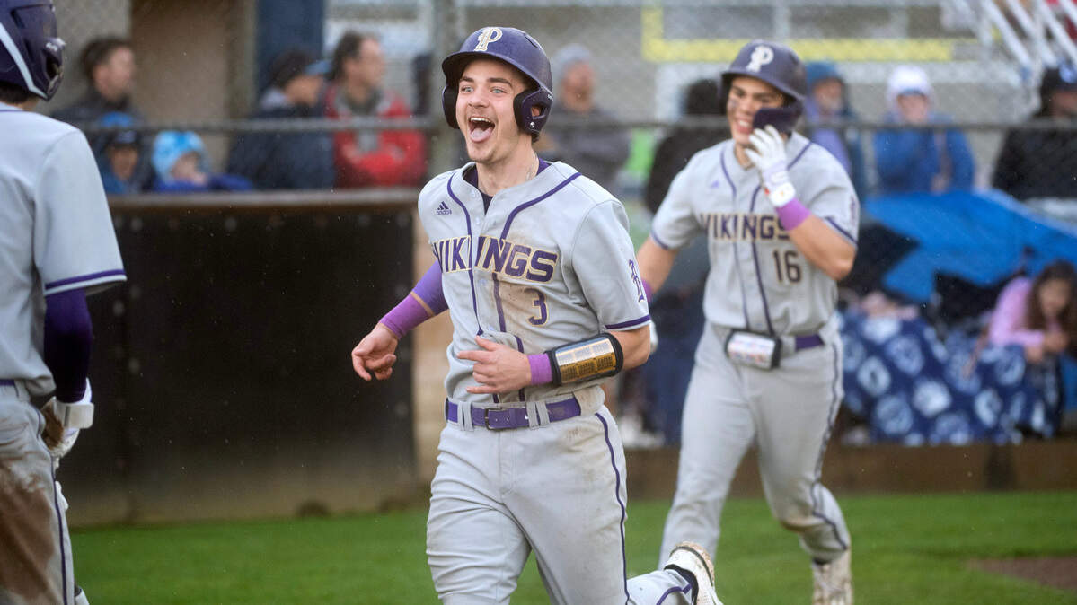 Puyallup’s Tristan Ringrose (3) and Kai Halstead celebrate after scoring on a two-run double by teammate Mason Pike during Wednesday afternoon’s baseball game against the Olympia Bears at Olympia High School in Olympia, Washington, on April 12, 2023. Puyallup won the game, 6-2.