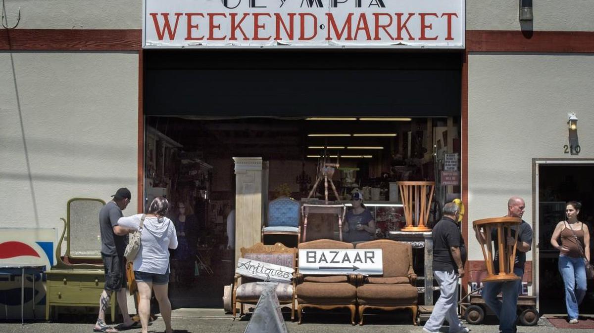 Customers shop during the weekend at the Olympia Flea Market in Olympia in June.