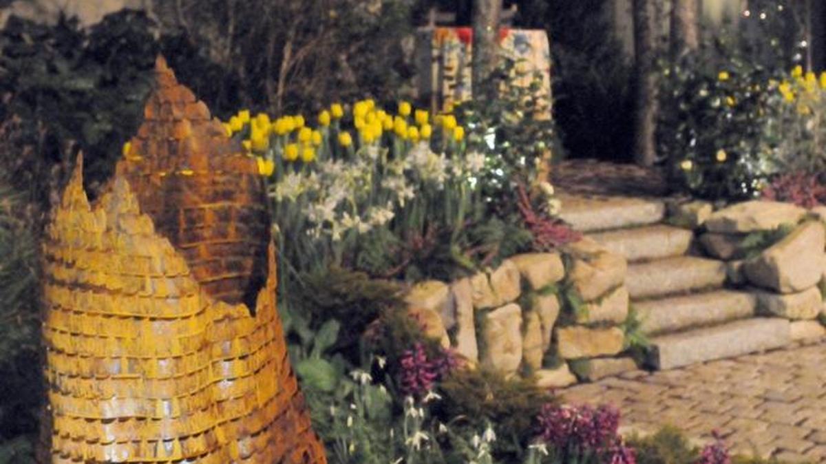 A metal stump sculpture made from band saw blades and a pergola made from alder logs were the focal points of a display garden at the 2015 Northwest Flower and Garden Show, by Oliana Gardening. It's called "Pining Over Yew - a Love for Every Season."