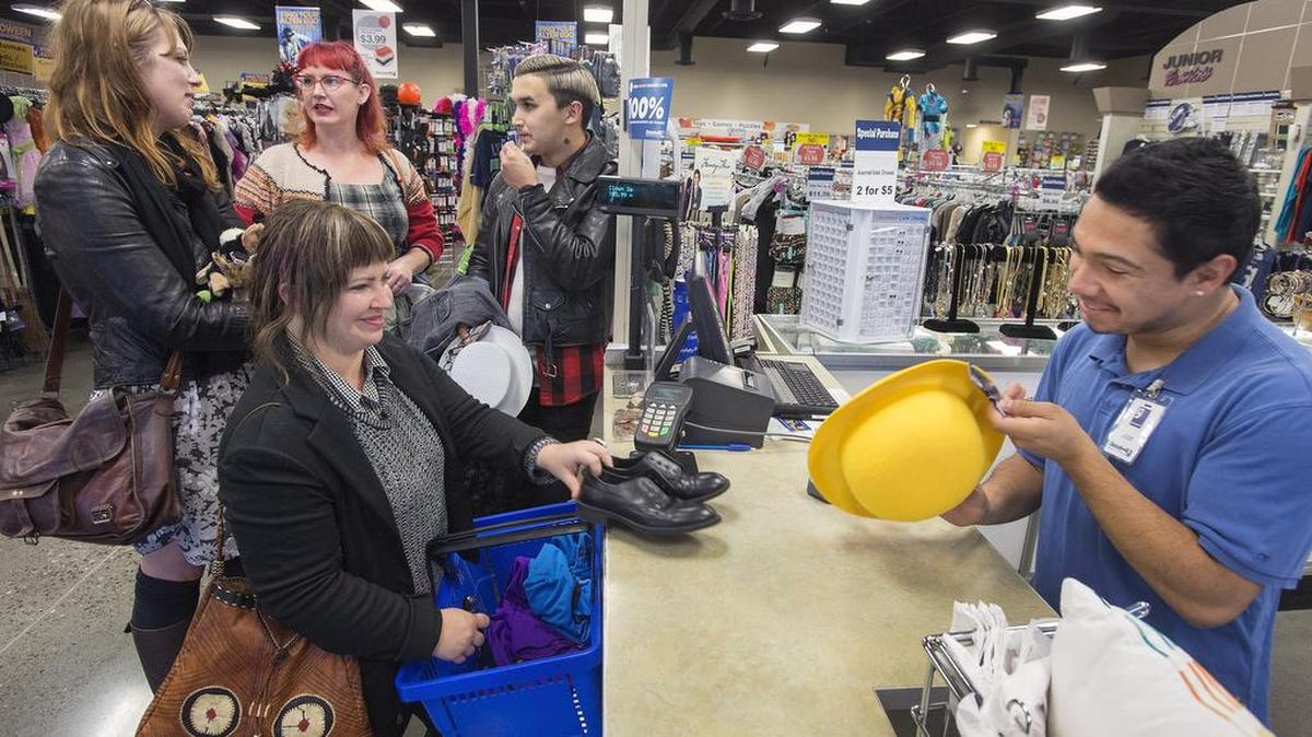 Three clothing-savvy shoppers, having their purchases rung up by cashier Jose Iniguez, were recruited by The News Tribune to design creative Halloween costumes on the cheap. Clockwise from foreground left: Lisa Fruichantie, Jayme Lillie and friend Lija Silver, and J.D. Elquist.
