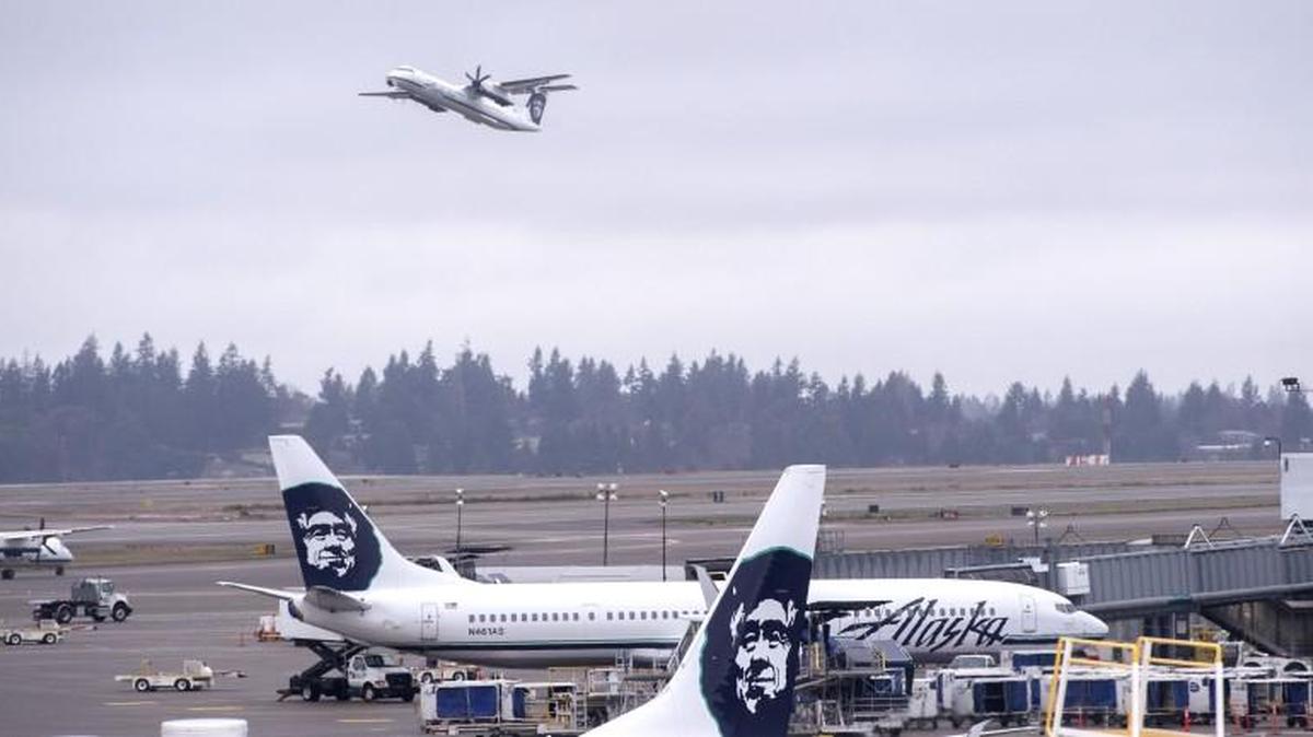Alaska Airlines planes taxi away from the north terminal at Seattle-Tacoma International Airport on Feb. 19, 2015.