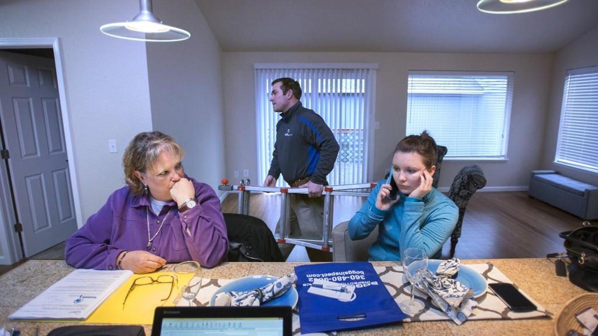 Broker Leslie Center, owner of Thunderbird Real Estate, and home inspector Bill Ryan of Boggs Inspection Service, help first-time home buyer Nicole Boatright, an assistant nutrition program director with the Clover Park School District, during an inspection of the two-bedroom home in Tumwater that Boatright was buying in January 2016. The process and prices have gotten more difficult since then.
