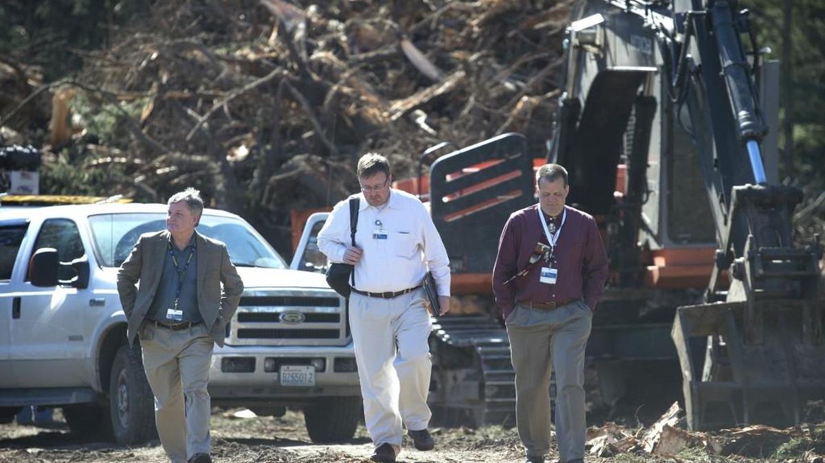 From left, facilities director Geoff Glass walks with communications manager Chris Thomas and chief executive Dr. Rik Emaus as they check on demolition and renovation work at the southwest end of the Providence chemical dependency center in Lacey. Glass said patient services continue uninterrupted even as work progresses on the Providence Multi-Service Clinic on the site.