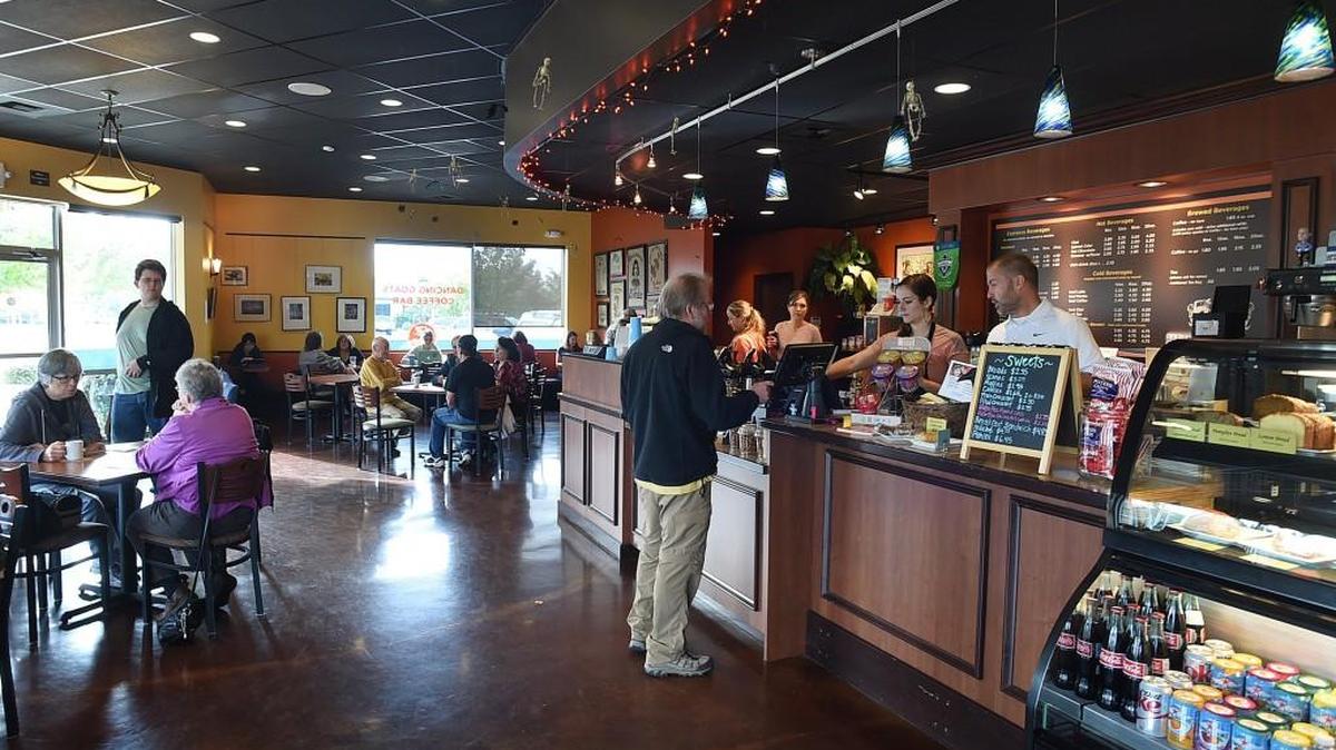 Dancing Goats Coffee Bar owner Chris Reimertz (behind counter, at right) has seen a steady increase in business since the opening of the new adjacent Lacey campus of South Puget Sound Community College.