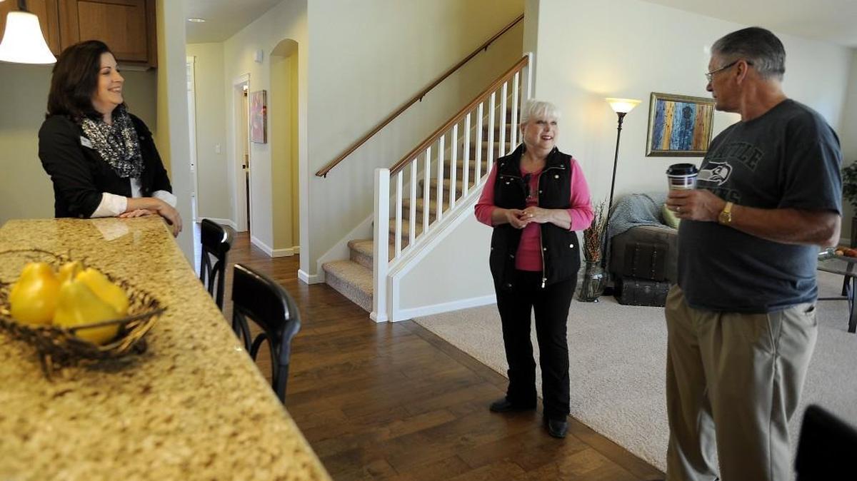 
Real Estate broker Francine Viola chats with prospective home buyers Larry and Marcy Rosenlund at her Coldwell Banker open house Sunday in the Campus Highlands subdivision in Hawks Prairie. The Roselunds have their eye on another home, which is slated to be built soon.
