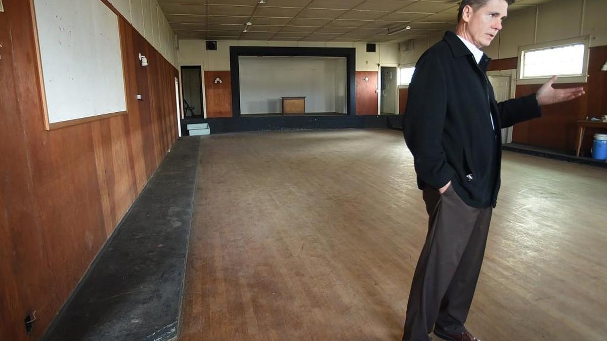 During a Dec. 9 tour, former Chambers Prairie Grange No. 191 owner Tom Schrader discusses plans to restore the 106-year-old community hall at the intersection of Yelm Highway and Henderson Boulevard to its former glory.