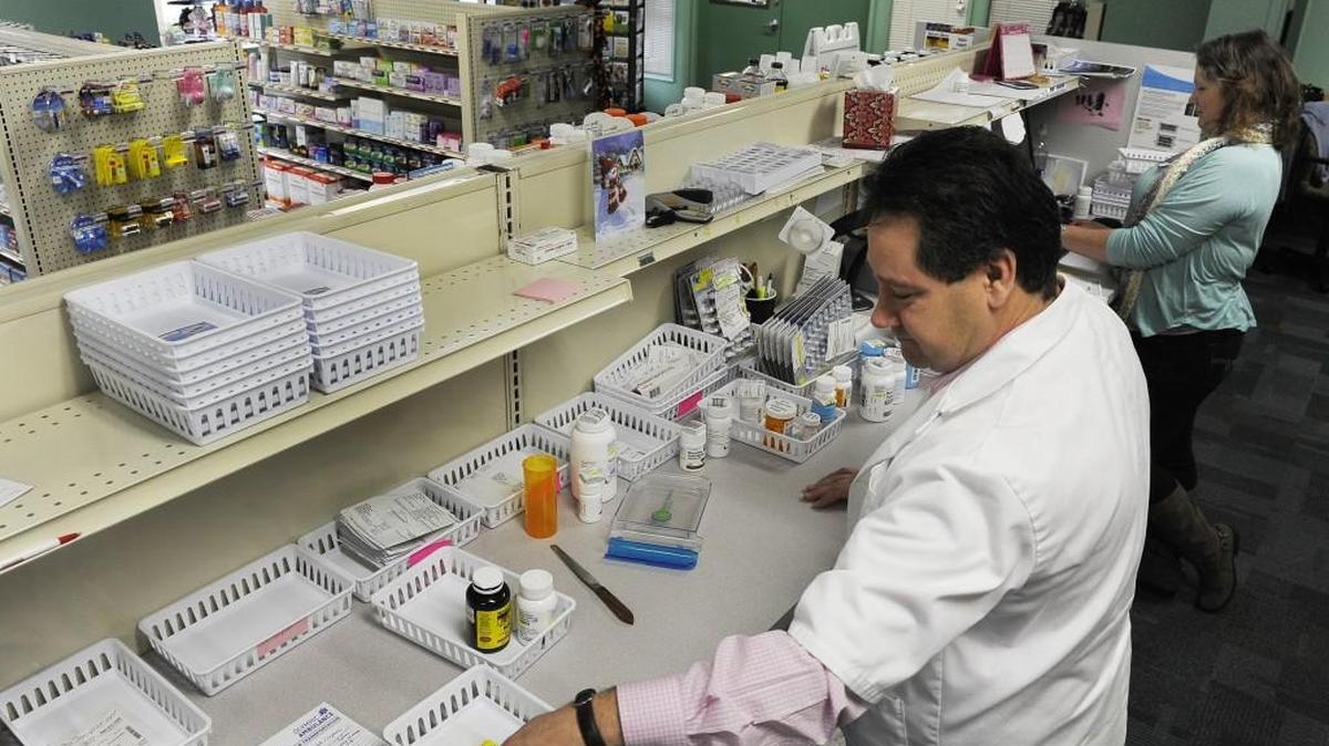 West Olympia Pharmacy owner and pharmacist Jim Perrou prepares prescriptions with technician Kim Casebolt at their Yauger Way location.