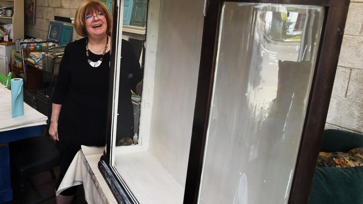 Standing in their new Courtyard Studio 721 building on June 22, owner Mary Corso talks about this curio cabinet restoration project underway.