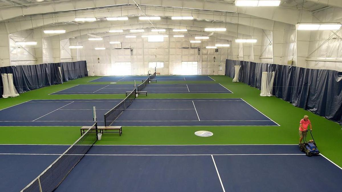 
Dean Schwickerath runs a floor cleaner along the playing surface of the new 25,500 square-foot complex Monday at the Steamboat Tennis and Athletic Club. Owner Drake Nicholson aims for an October opening.
