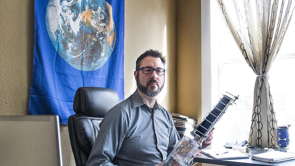 Tacoma’s Michael Laine, the visionary behind the LiftPort Group, holds a prototype of a climbing robot that test the mechanics of the group’s robot space elevator that could someday climb a carbon nanotube cable into space.
