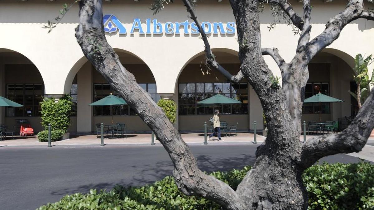 The entrance to an Albertsons grocery store in Tustin, Calif., in 2011. Albertsons shoppers can earn points to save up to $1 per gallon at Safeway gas stations, as well as participating Chevron and Texaco stations.