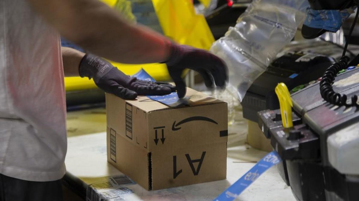 A worker tapes a box while packing items on Cyber Monday at the Amazon Fulfillment Center on Nov. 28, 2016 in San Bernardino, Calif. Amazon announced Thursday they will be hiring more work-at-home jobs in customer service.