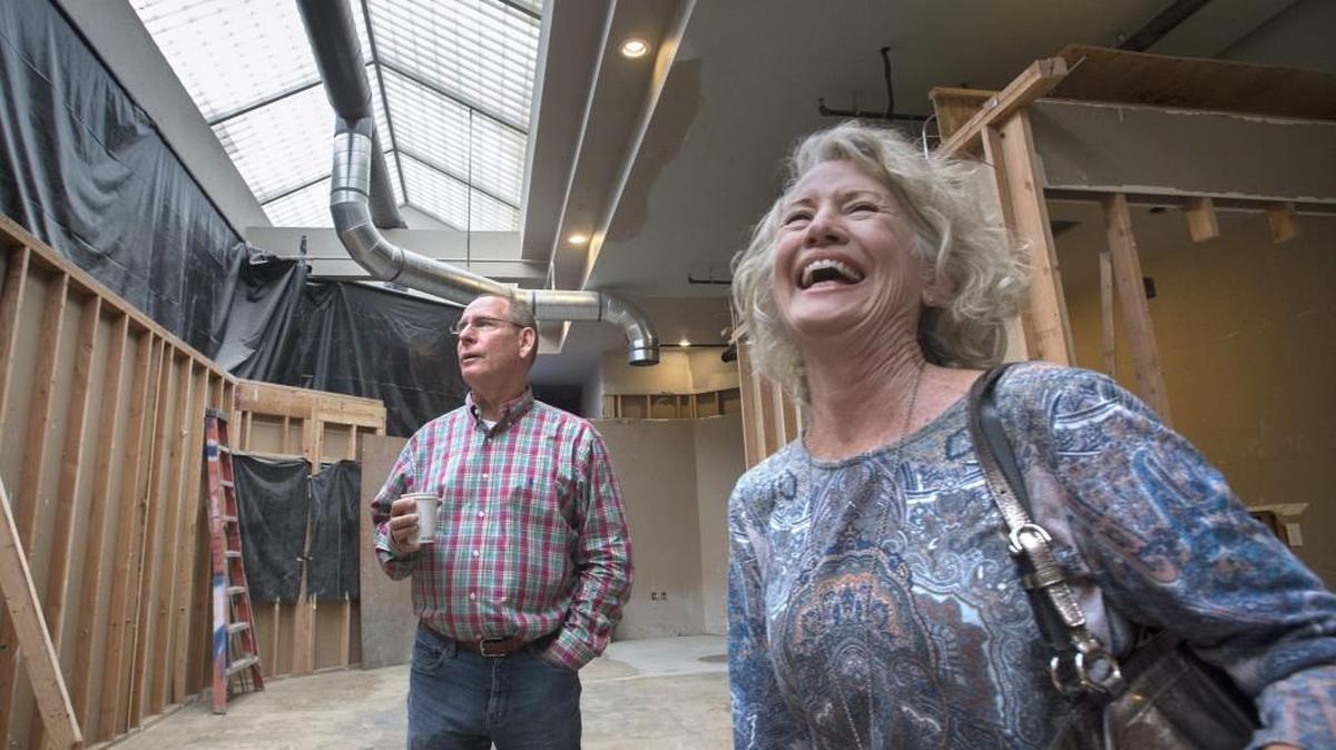 Tucked in behind the bustling lunchtime crowds at The Bread Peddler and Creperie in downtown Olympia, developers Gray Graham and wife, Joy Graham, survey what will be the open food court at their 222 Market building on Capitol Way North on Thursday, July 7, 2016.
