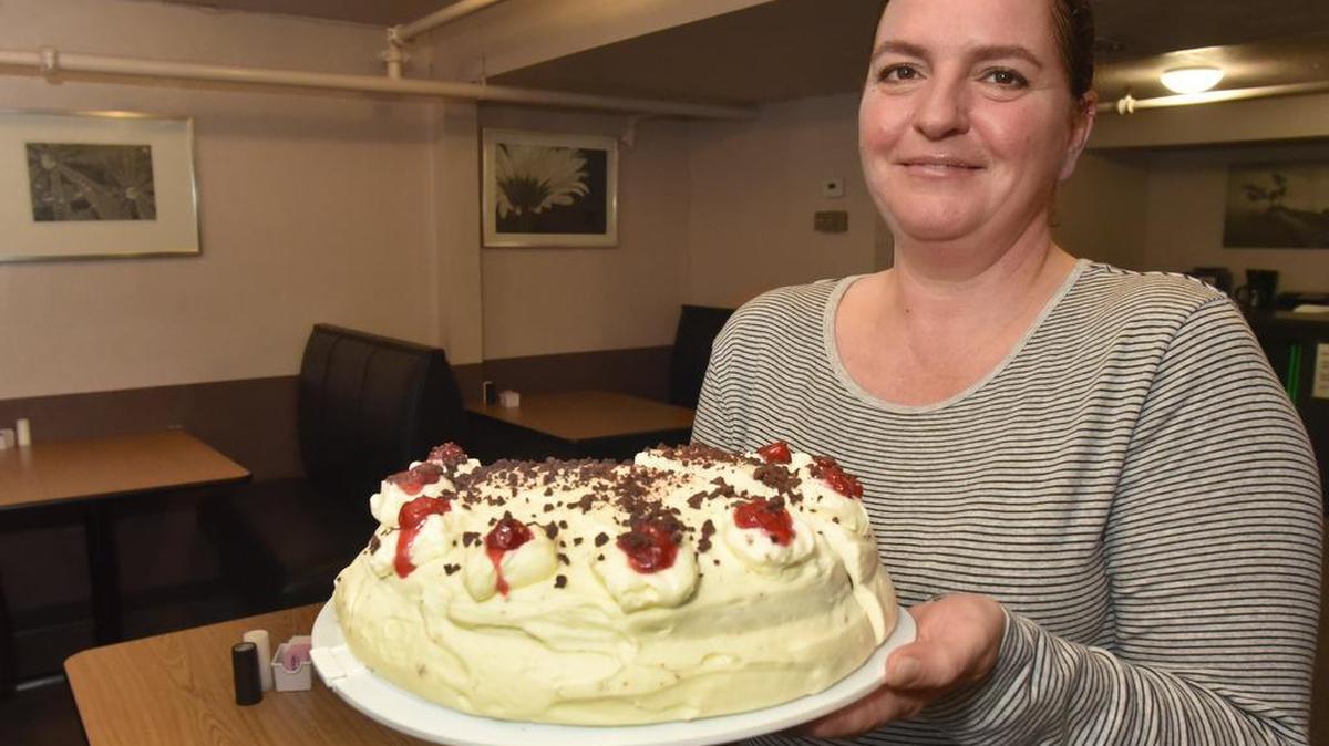 German Diner owner Mirjam Spring holds one of her Lacey restaurant's popular desserts — Black Forest Cake.