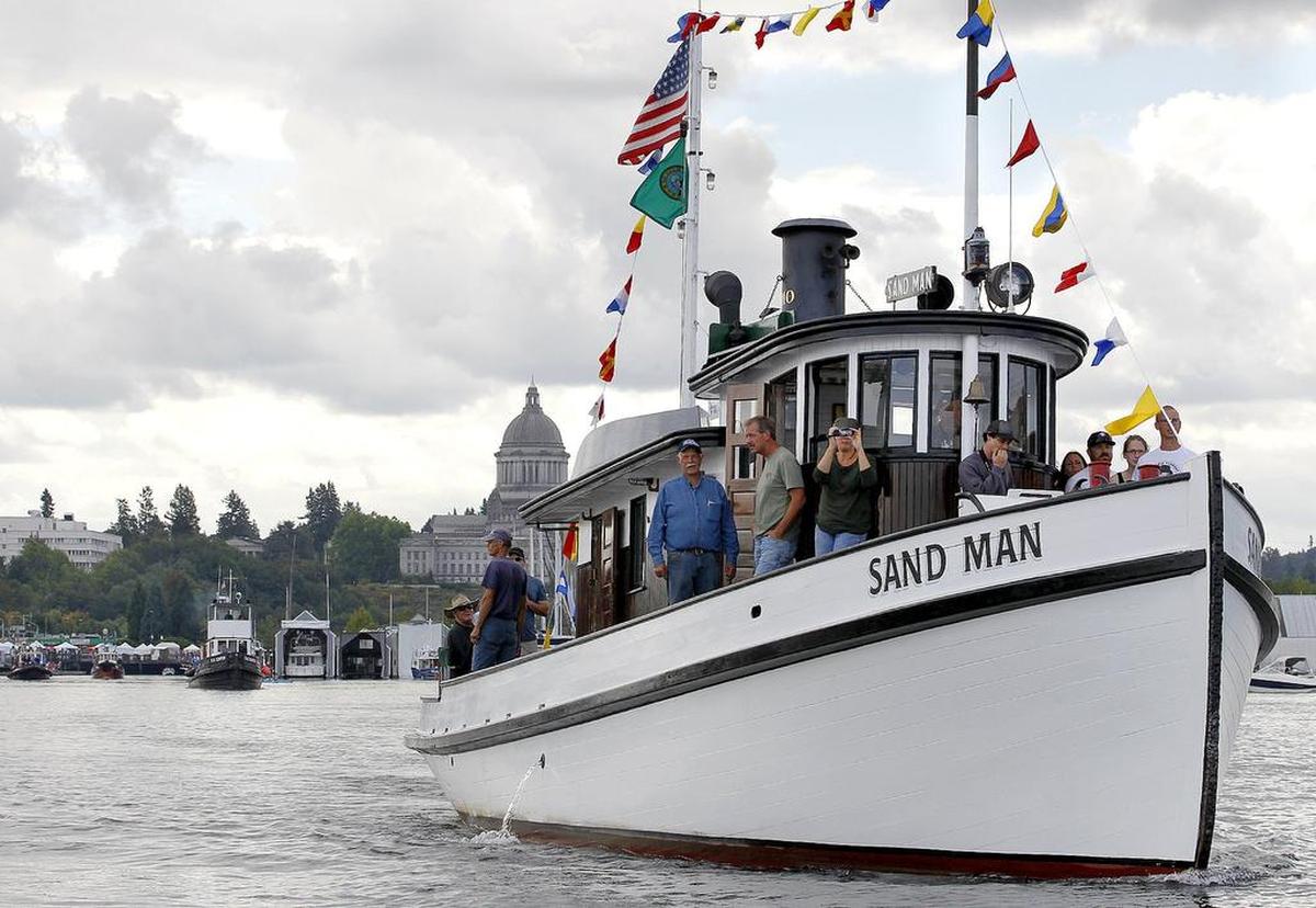 The local historic tug Sand Man heads out to the race course as drier weather greeted both racers and spectators alike for the 2014 Harbor Days tugboat races on Budd Inlet August 31st.