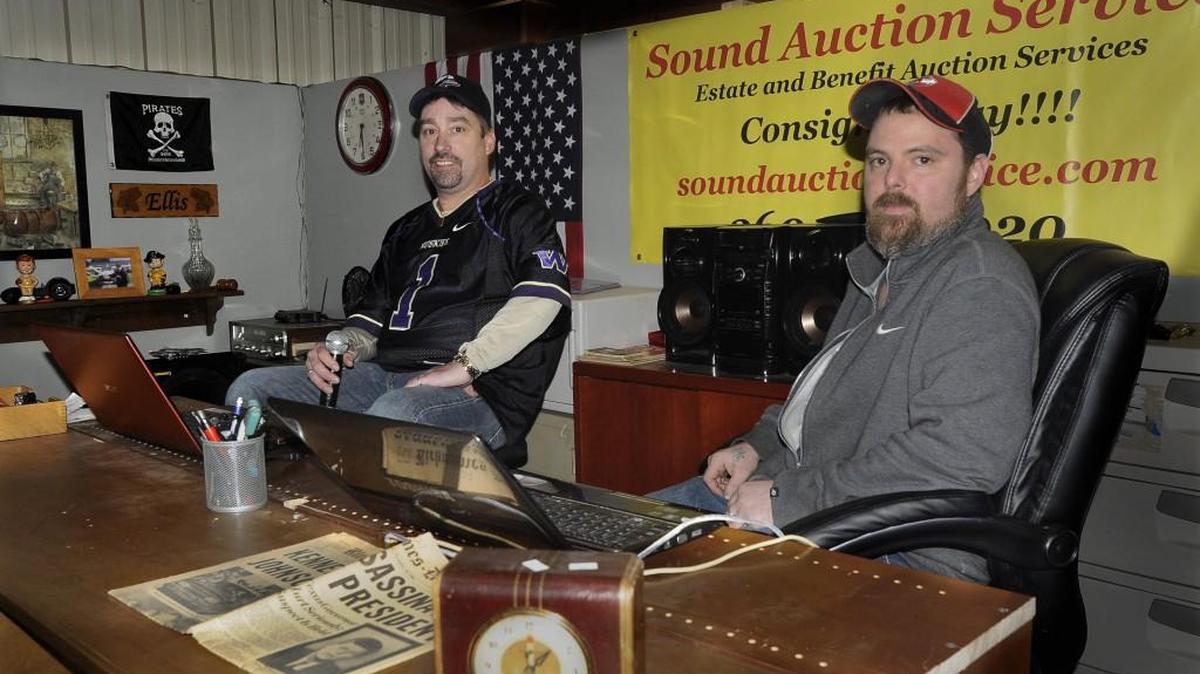 Cory Ellis, left, Sound Auction Service owner, and auction technician Joseph Nelson have seen rapid growth of the business, which recently added 2,400 square feet to its warehouse and gallery areas.