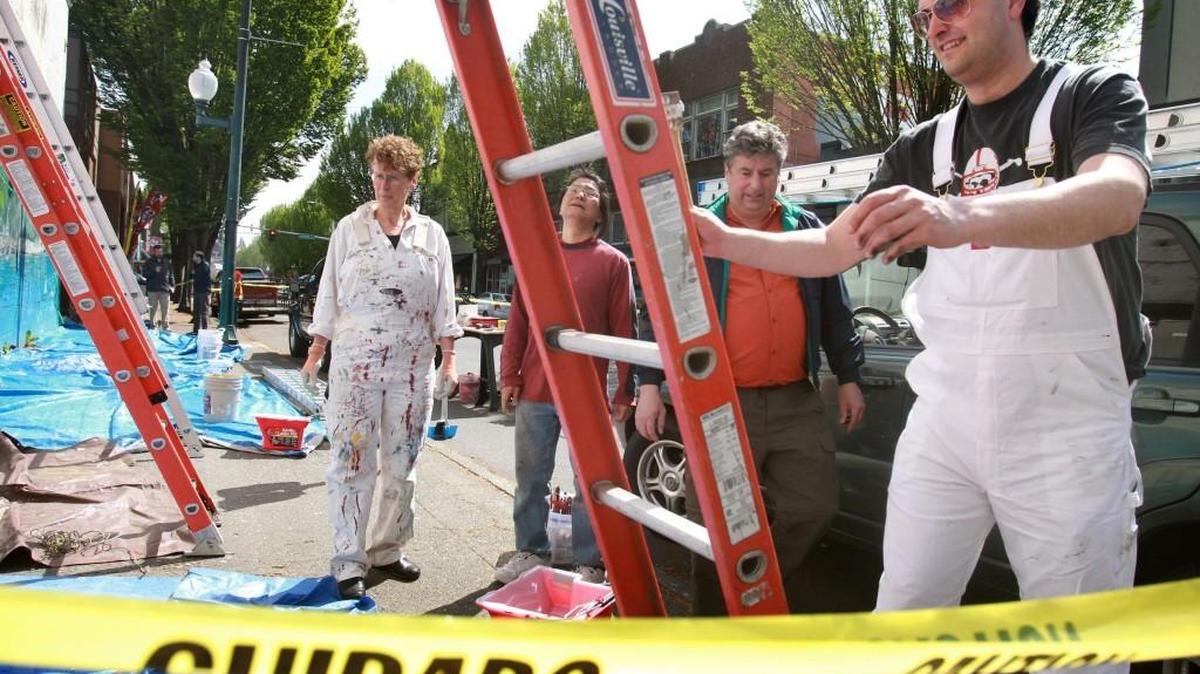 File photo: Anna Schlecht, left, is among the Volunteers in Paint who spent a vacation day in 2014 to help clean-up and paint the outside of the burned-out Griswold's Office Supply building in downtown Olympia.
