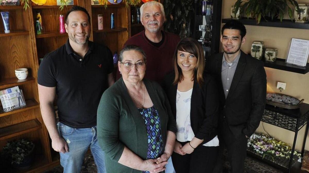 Former Aloha Tanning owners Ryan Hickey along with Glenda and Dave Pordon have handed over the reins to new owners Krystal King, a former employee, and Andrew Metcalf (far right). photo taken March 7th