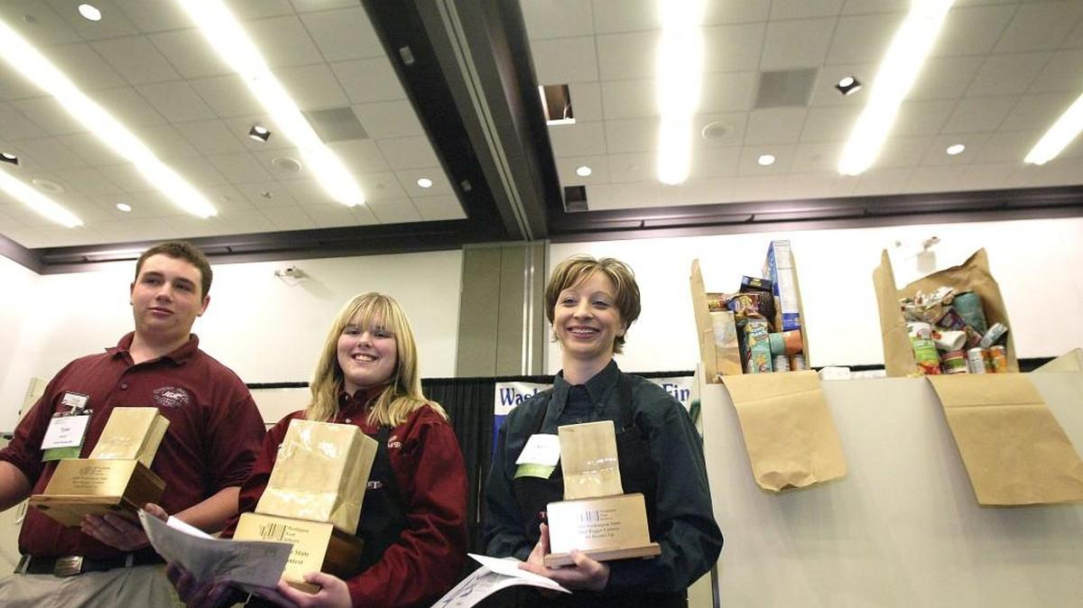 Andrea Light of Ralph's Thriftway in Olympia, right, came in second place to Glenn Cragun, center, of Yoke's Fresh markets in Deer Park, during competition in the 2009 "Best Bagger" State Finals competition held at the Greater Tacoma Convention Center. Tyler Braclet, left, of IGA in Ocean Shores came in third.