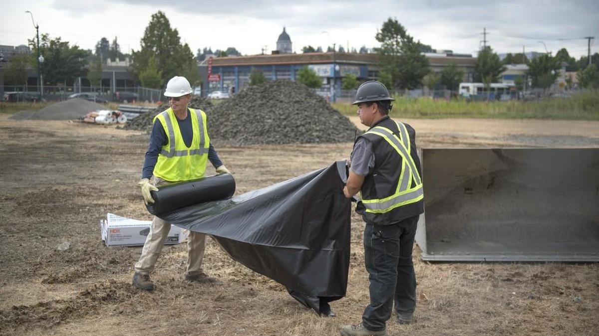 Project manager Tony Bahnick (left) and site superintendent Alvin Perschon, both with general contractor IO Environmental & Infrastructure of Redmond, begin site preparation for the enviromental cleanup of the Port of Olympia's East Bay property along State Avenue in downtown Olympia.