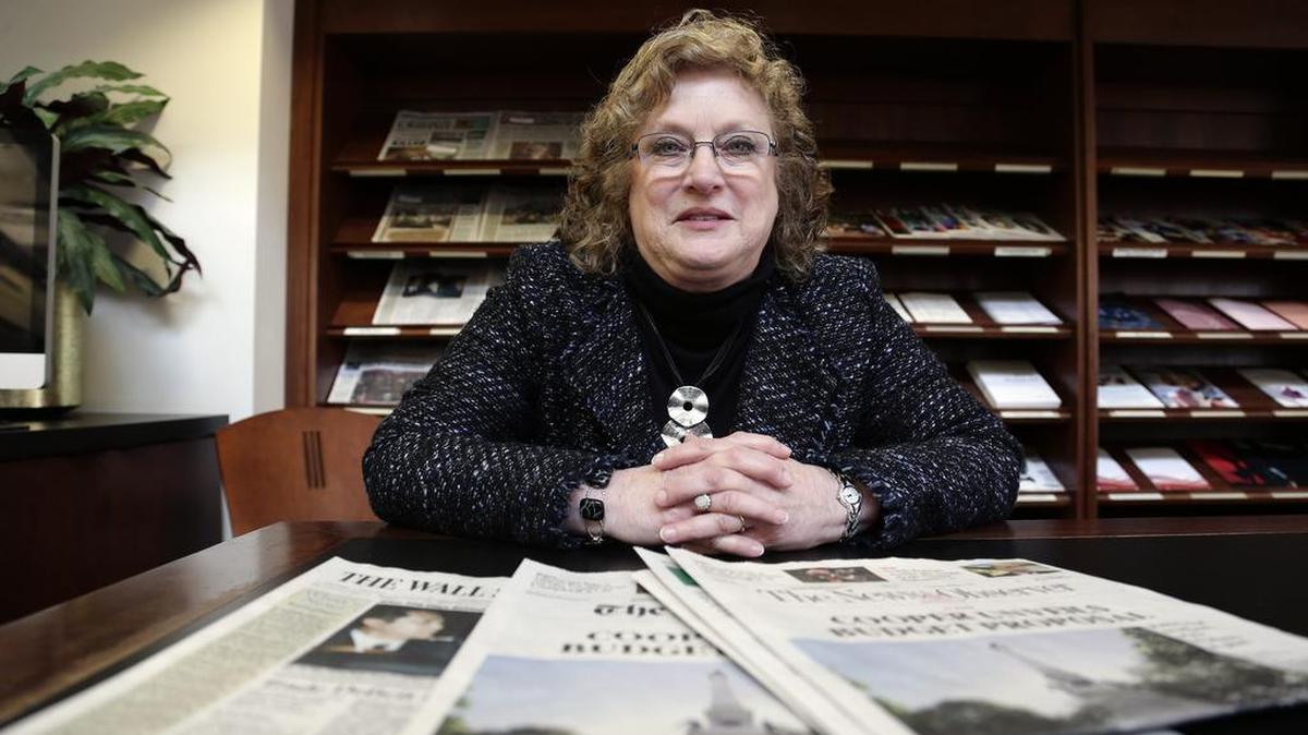 Penelope Muse Abernathy, a University of North Carolina professor, stands with the daily newspaper selection in the Park Library at the School of Journalism in Chapel Hill, N.C. "Strong newspapers have been good for democracy, and both educators and informers of a citizenry and its governing officials. They have been problem-solvers," said Abernathy, who studies news industry trends and oversaw the "news desert" report released the previous fall.