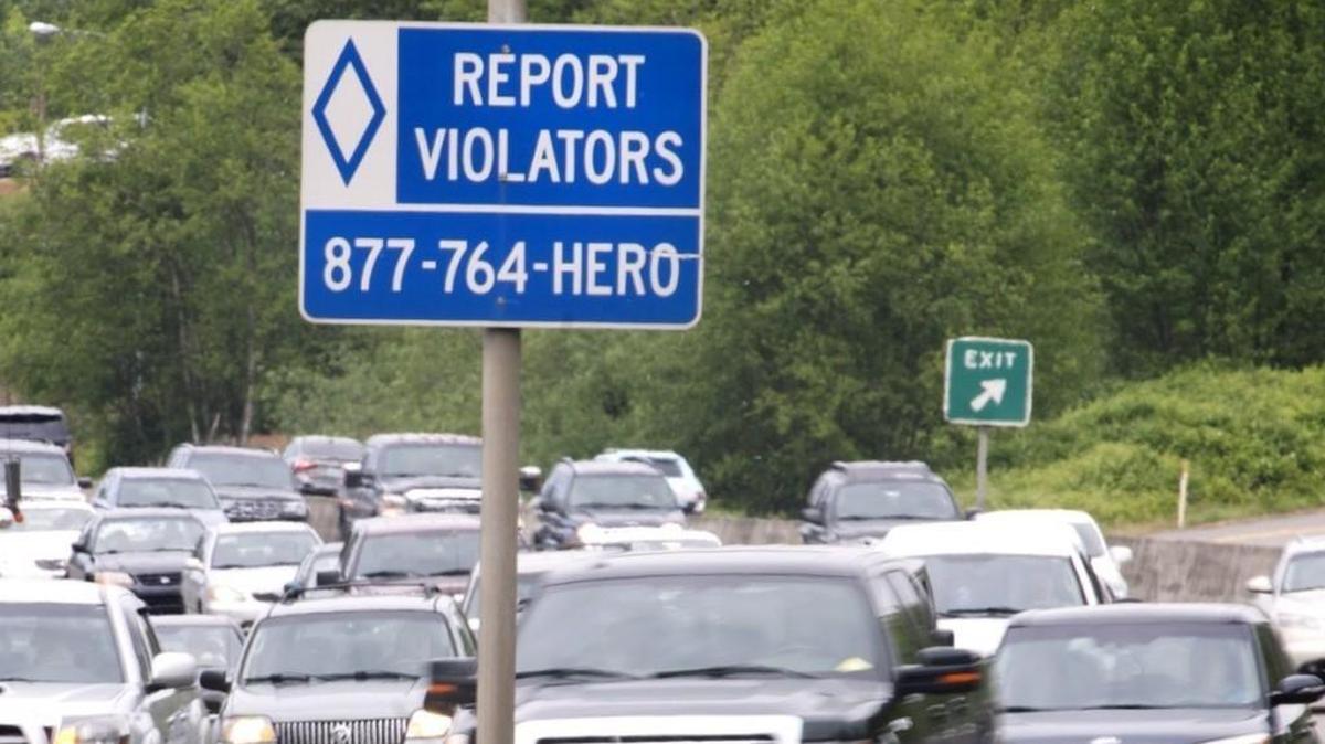 A DOT sign on Highway 167 northbound in Kent encourages drivers to report HOV lane violators. Photo taken on Thursday, April 28, 2016.