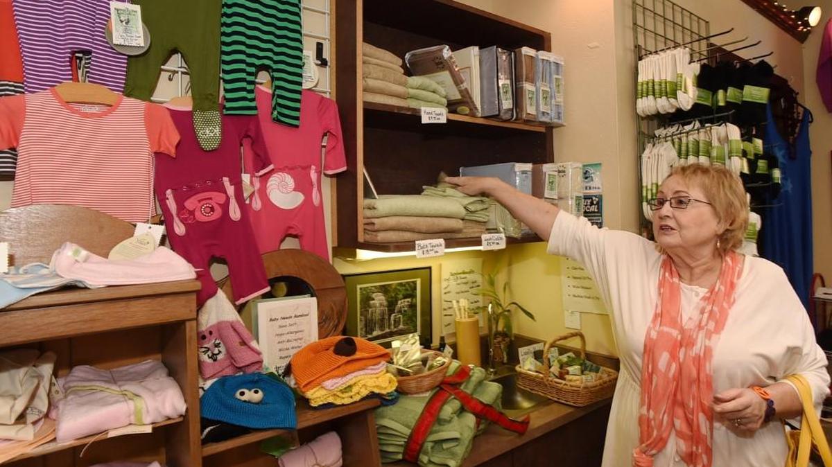 Bamboo & You owner Carleta Rawlings explains the benefits of bamboo-made clothing as she prepares to move the shop one block up to 202 Fifth Ave. in May. The store and others will be part of Girls Night Out, Friday and Saturday in downtown Olympia.