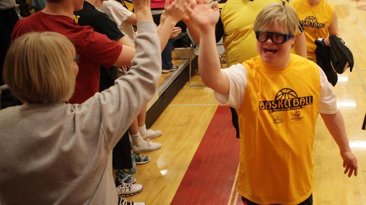 More than 80 local Special Olympics' athletes are greeted by spectators as they enter Capital High School before the "Pack the Gym" basketball tournament in 2014.