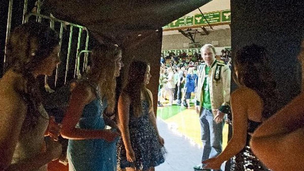 Olympian 2013 file: Principal Jeff Broome checks on the princesses before the Tumwater High School Homecoming student assembly, October 25, 2013. Some students are calling for Broome to reverse a decision he made in suspending a student on Monday over a social media post.
