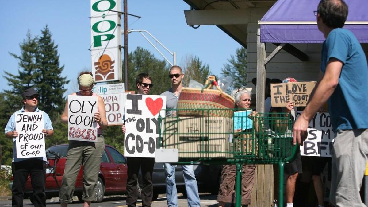 FILE PHOTO: Supporters of the Olympia Food Co-op rally outside the eastside Olympia store in 2010.